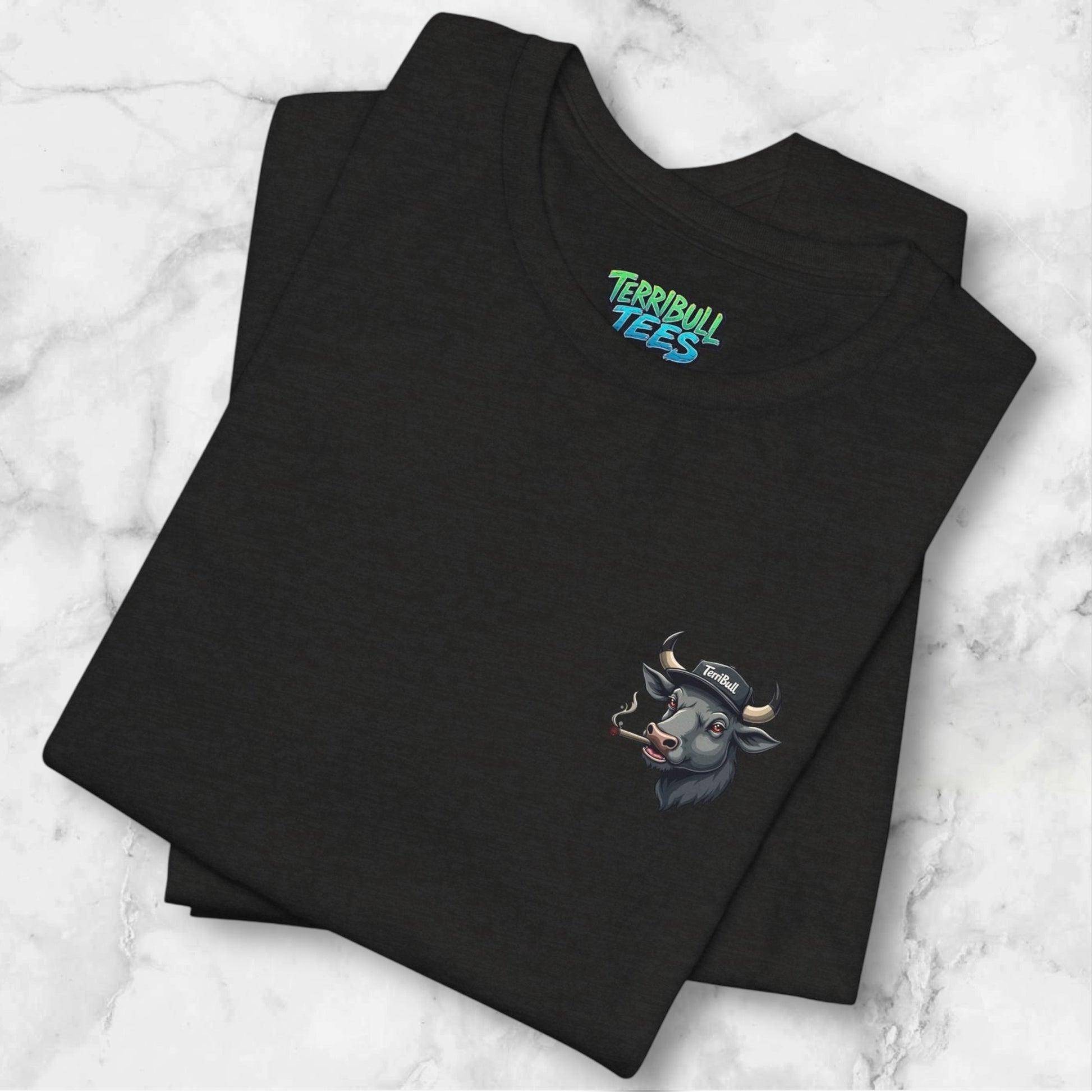 Black t-shirt with a logo and 'Terribull Tees' branding on a marble surface.