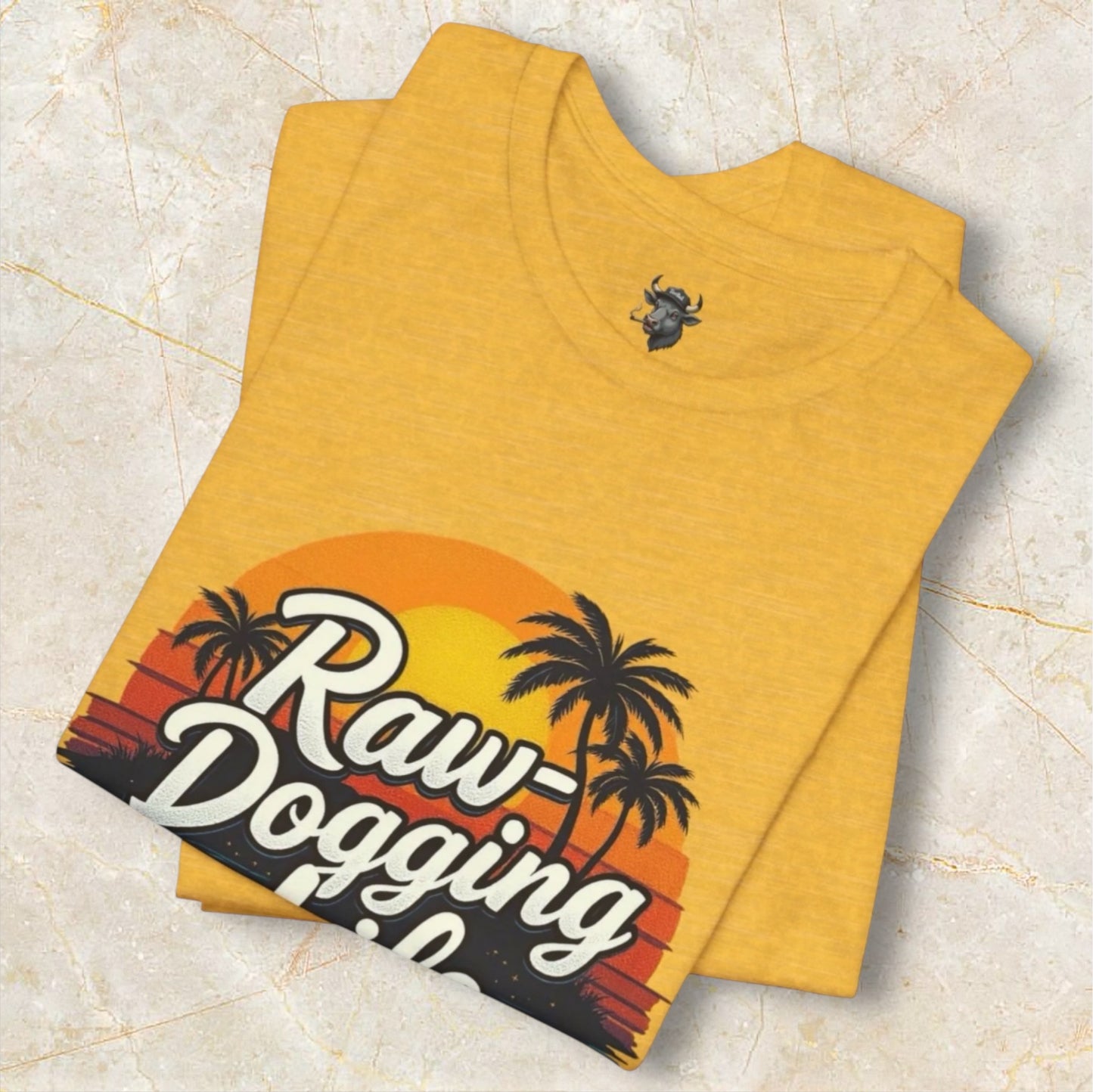 Yellow folded t-shirt with 'Raw-Dogging Life' graphic design, by Terribull Tees.